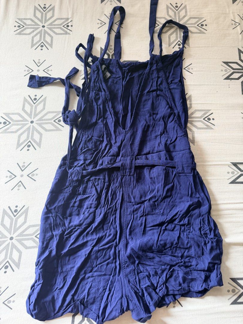 Forever 21 Contemporary Blue Romper Size M (Category: Rompers) located in Marikina City. Submitted by shasundaeclothings (Listing ID 1463033670, Image 2). Description: - Forever 21 Contemporary blue romper - Size: Medium (M) - Adjustable tie straps - Button details on the sides - Elasticated waist with a tie belt - Lightweight fabric - Ideal for casual wear.