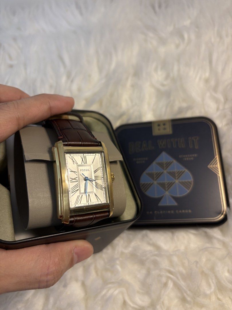 Fossil Rectangular Watch with Brown Leather Strap (Category: Women's Watches) located in Quezon City. Submitted by AAAAAF14 (Listing ID 1463081790, Image 2). Description: Like new, bought then stored with my initials at the back. with protective film. - Gold-tone Fossil watch - Rectangular face with Roman numerals - Blue hands - Brown leather strap - Comes with original Fossil tin - Includes 'Deal With It' playing cards - Ideal for everyday wear 