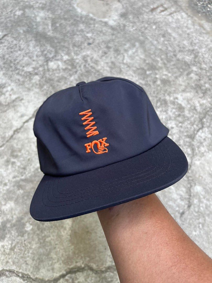Fox Racing Navy Blue Snapback Cap (Category: Caps & Hats) located in Polomolok. Submitted by paollette1214 (Listing ID 1463042205, Image 3). Description: - Navy blue Fox Racing cap - Features orange embroidered logo on front and back - Adjustable strap for a comfortable fit - Made from a polyester and spandex blend - Ideal for casual wear or sports activities.