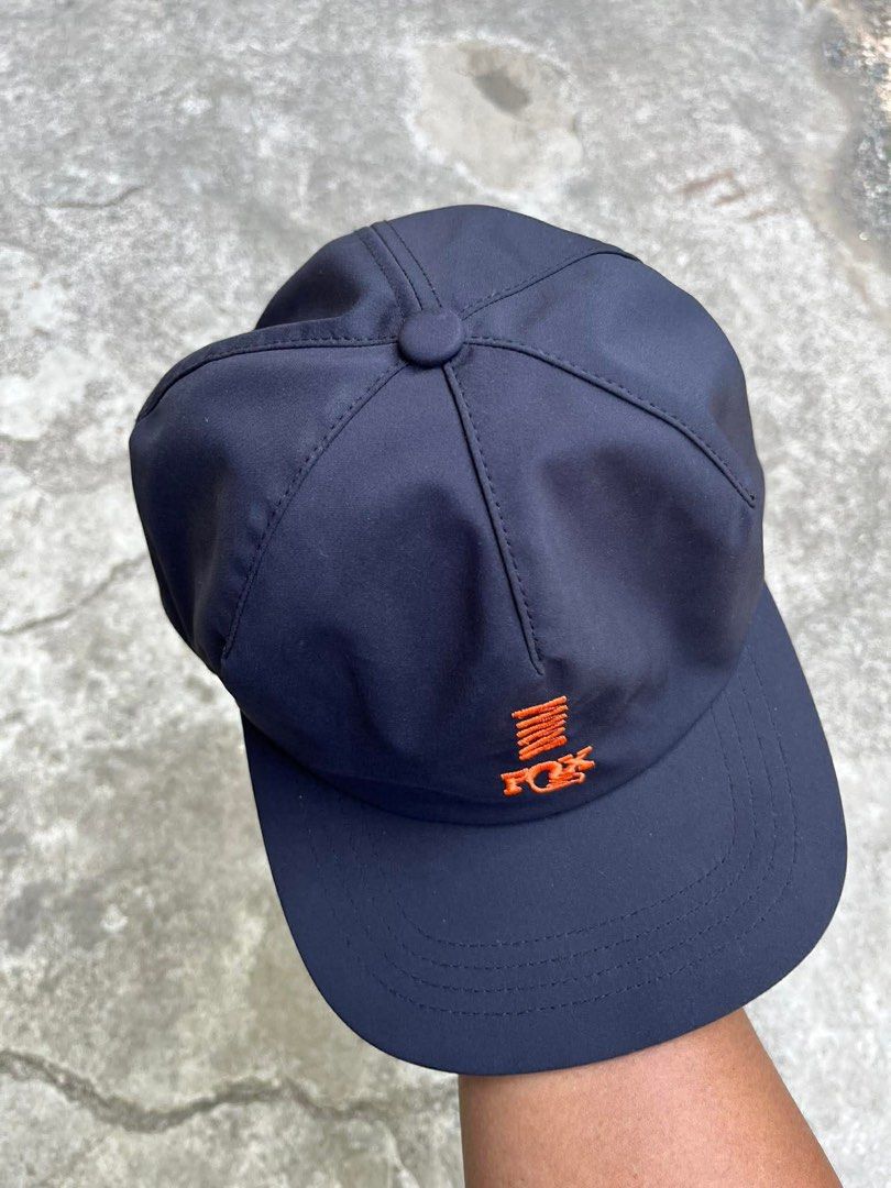 Fox Racing Navy Blue Snapback Cap (Category: Caps & Hats) located in Polomolok. Submitted by paollette1214 (Listing ID 1463042205, Image 1). Description: - Navy blue Fox Racing cap - Features orange embroidered logo on front and back - Adjustable strap for a comfortable fit - Made from a polyester and spandex blend - Ideal for casual wear or sports activities.