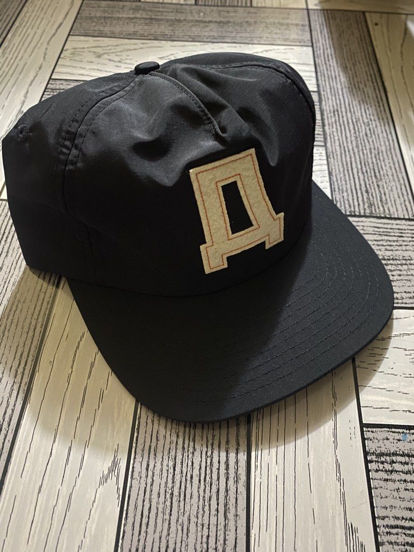 Fugazzi Amsterdam Black Cap with 'A' Logo (Category: Caps & Hats) located in Manila. Submitted by hattearss (Listing ID 1463054237, Image 1). Description: - Black cap from Fugazzi Amsterdam - Features a cream 'D' logo on the front - Small Fugazzi tag on the side - Adjustable strap at the back - Perfect for everyday wear.