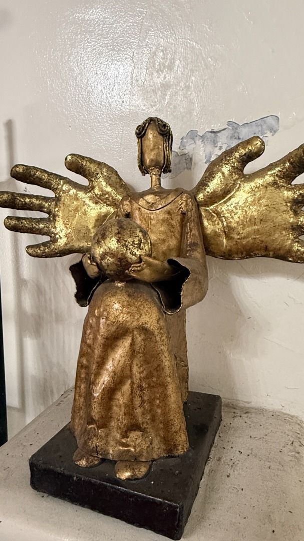 Gilded Metal Angel figurine (Category: Other Home Decor) located in Cainta. Submitted by villa_paraiso (Listing ID 1462957854, Image 2). Description: Unique angel sculpture with multiple hands - featuring a rustic, textured gold finish - Holding a child - Sturdy dark base - Adds character and is a great conversation starter - Ideal for display in any space price is slightly negotiable.