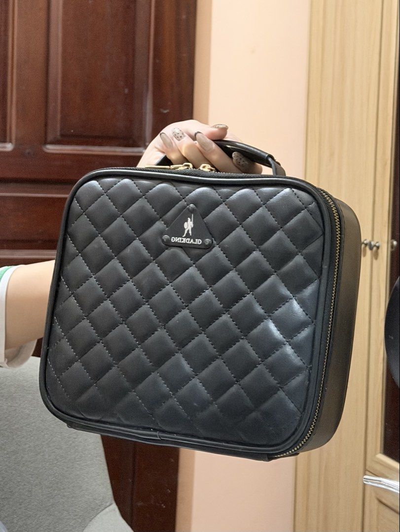 GLADKING Quilted Black Makeup Vanity Case (Category: Makeup) located in Manila. Submitted by margatuazon25 (Listing ID 1463025804, Image 1). Description: - very cutesy makeup bag ✨ - Style: Black quilted makeup case - Features: Handle, zipper closure - Interior: Adjustable dividers for customizable organization - Ideal for: Travel or home use - Benefit: Keeps cosmetics neat and tidy .