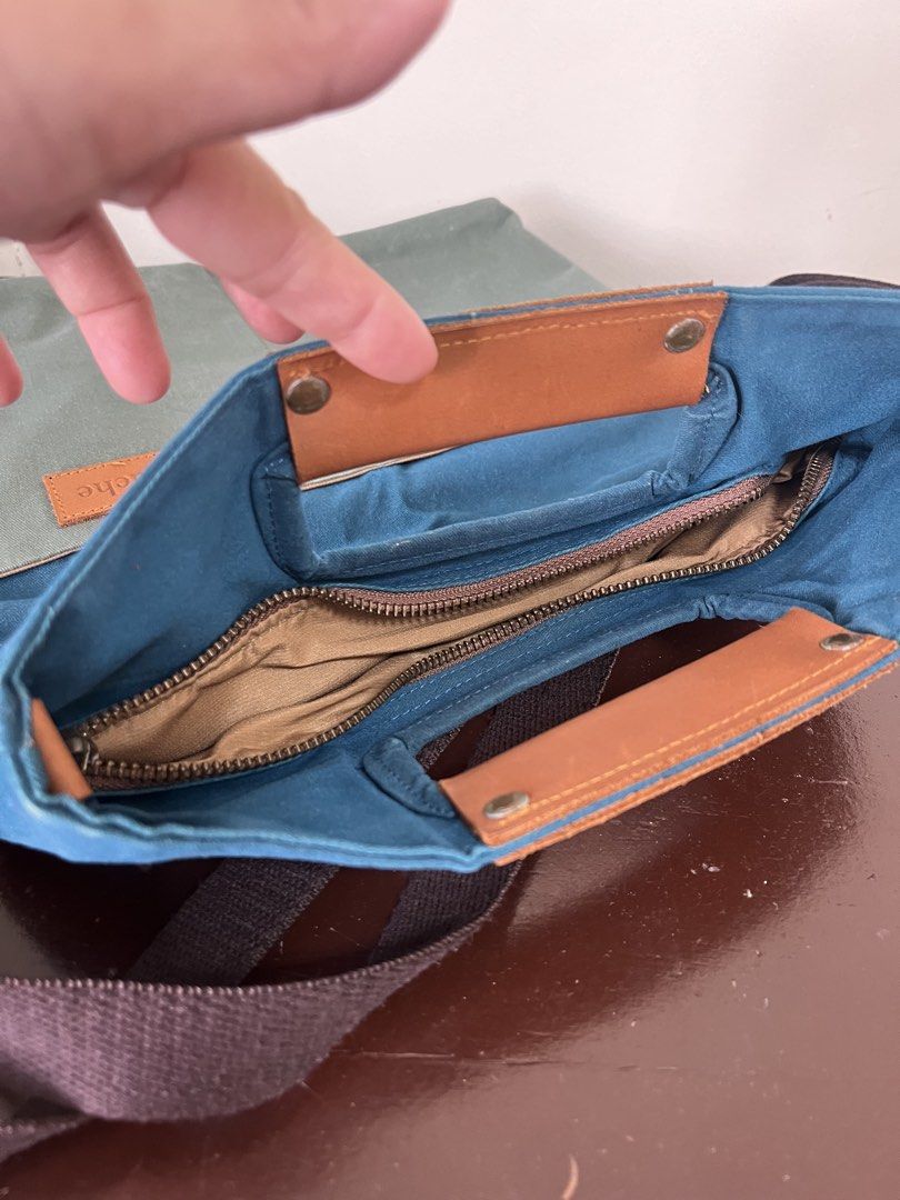 GOUACHE Canvas Tote Bag with Leather Handle (Category: Tote Bags) located in Taguig. Submitted by decluttering_lola (Listing ID 1462960916, Image 3). Description: - Brand: GOUACHE - Style: Two-tone Canvas Tote Bag - Colors: Teal blue (top), Olive green (bottom) - Features: Comfortable leather handle, detachable shoulder strap, interior organizing pockets - Closure: Snap closure at the top - Ideal for: Everyday use, travel.