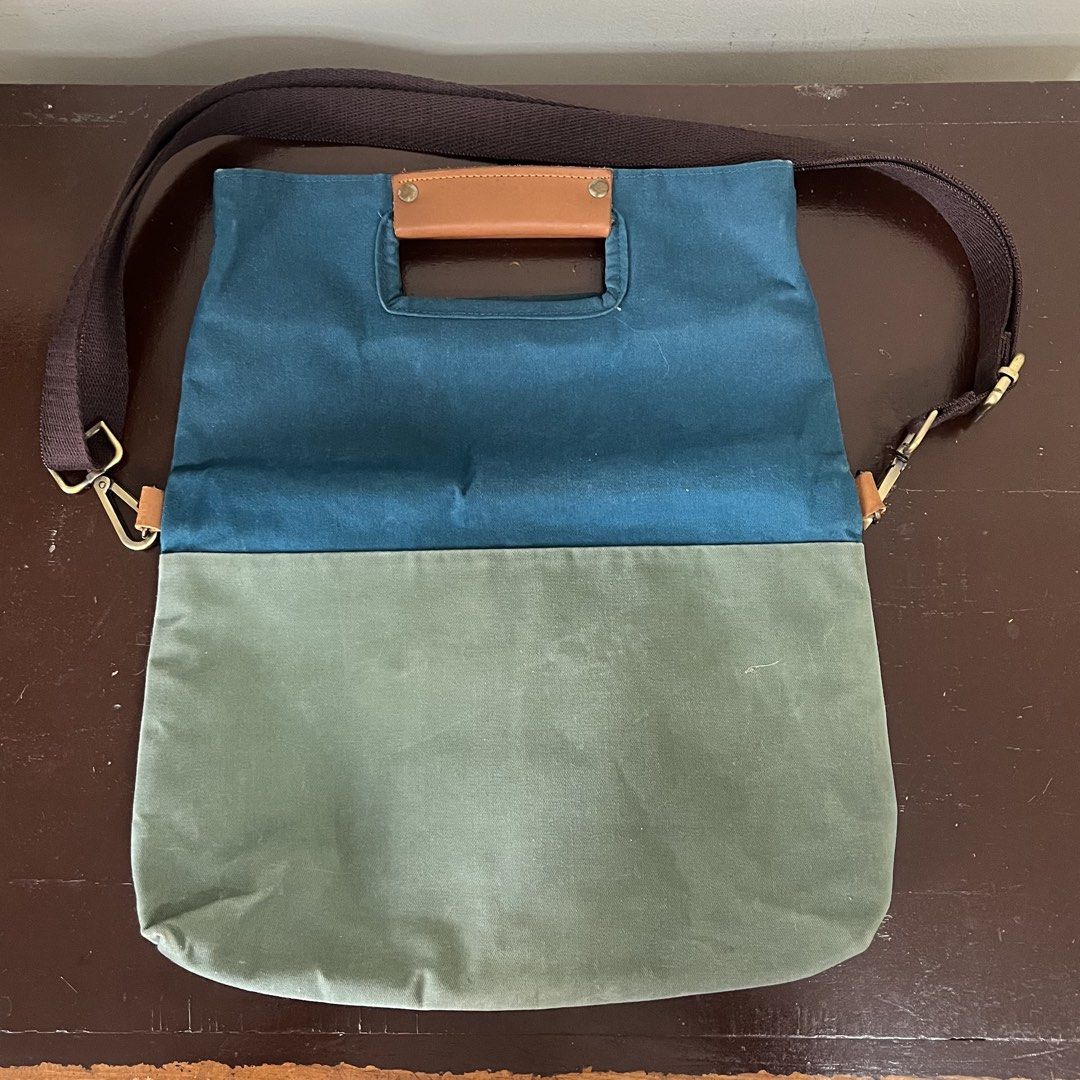 GOUACHE Canvas Tote Bag with Leather Handle (Category: Tote Bags) located in Taguig. Submitted by decluttering_lola (Listing ID 1462960916, Image 2). Description: - Brand: GOUACHE - Style: Two-tone Canvas Tote Bag - Colors: Teal blue (top), Olive green (bottom) - Features: Comfortable leather handle, detachable shoulder strap, interior organizing pockets - Closure: Snap closure at the top - Ideal for: Everyday use, travel.
