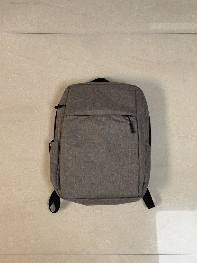 Gray Office Laptop Backpack (Category: Backpacks) located in Paranaque City. Submitted by thrifty_findz (Listing ID 1462969611, Image 1). Description: Streamline your daily routine with this sleek, minimalist heather grey backpack built for work, school, or travel. It features a spacious zippered main compartment, a hidden horizontal front pocket for quick access, and padded adjustable shoulder straps for all-day carrying comfort. Lightweight yet
