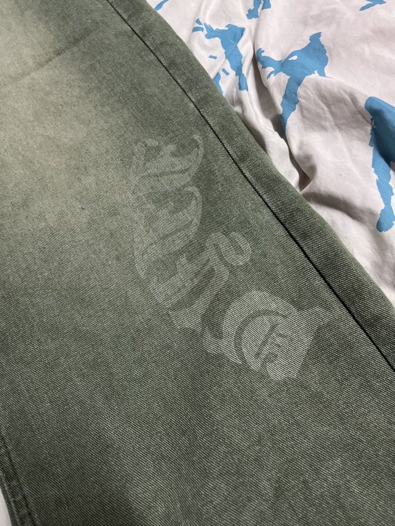 Green Washed y2k baggy pants (Category: Jeans) located in Manila. Submitted by lokeh (Listing ID 1463040237, Image 2). Description: - Green washed denim jeans - Features a gothic-style print on front and back - Relaxed fit, wide leg - Ideal for streetwear outfits - Please check photos for detailed print views.