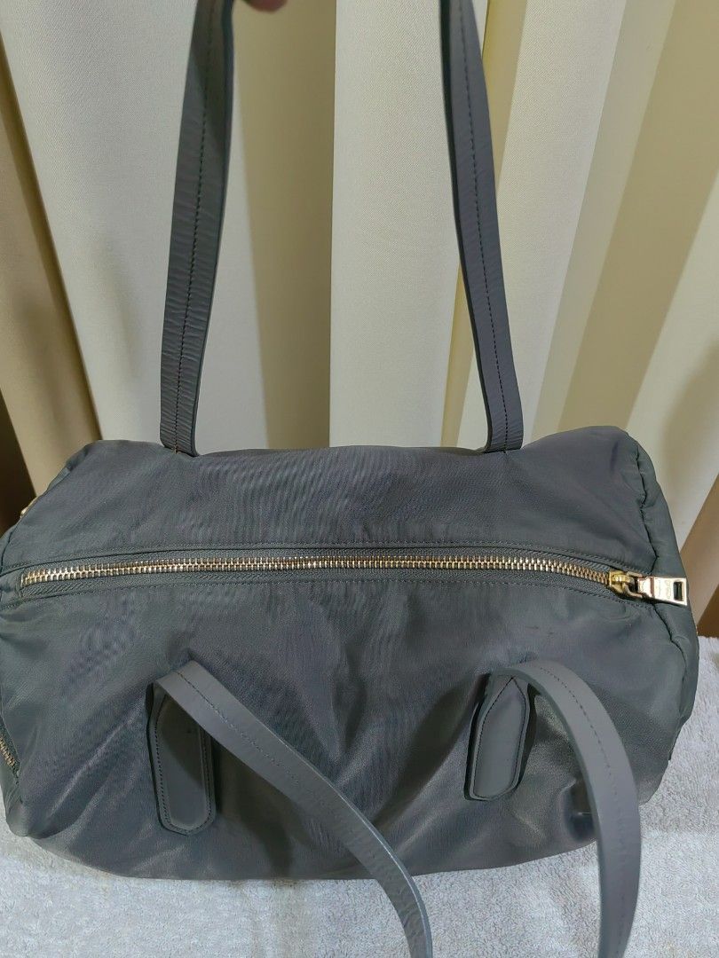 Grey Nylon Leather Tote Bag (Category: Shoulder Bags) located in Makati City. Submitted by prelovedtreatedwithlove (Listing ID 1463003970, Image 3). Description: - Grey tote bag - Material: Nylon with leather trim - Hardware: Gold details - Closure: Zipper - Interior: Spacious main compartment with one zippered pocket - Perfect for: Everyday use or travel -Maganda ang leather quality. Walang rubs - Issue : last pic ung brand nawala. A-146.