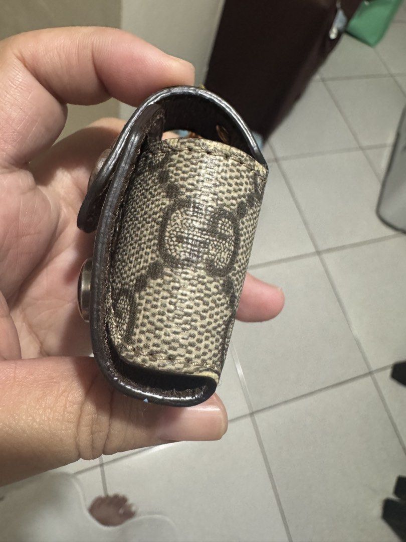 Gucci GG Monogram Pouch Keychain Holder (Category: Luxury Bags & Wallets) located in Marilao. Submitted by cj458678 (Listing ID 1463043099, Image 2). Description: - Authentic Gucci pouch - Classic GG monogram print in brown and beige - Secure snap button closure - Signature metal GG logo detail - Small loop for attaching to keys or bag - Ideal for small essentials like coins or earbuds Purchase for 19,800 Apple Airpods ver.1 .