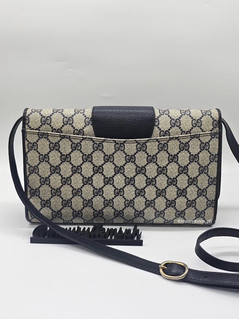 Gucci Monogram Shoulder Bag (Category: Luxury Bags & Wallets) located in Pamplona. Submitted by luxuryitems_ph (Listing ID 1462996251, Image 2). Description: - Vintage Gucci shoulder bag - Classic GG monogram canvas - Black leather trim - Secure flap closure with gold-tone buckle - Adjustable leather strap - Timeless piece - Approx. dimensions: 9" x 6" x 2".