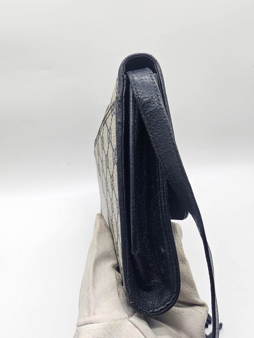 Gucci Monogram Shoulder Bag (Category: Luxury Bags & Wallets) located in Pamplona. Submitted by luxuryitems_ph (Listing ID 1462996251, Image 3). Description: - Vintage Gucci shoulder bag - Classic GG monogram canvas - Black leather trim - Secure flap closure with gold-tone buckle - Adjustable leather strap - Timeless piece - Approx. dimensions: 9" x 6" x 2".