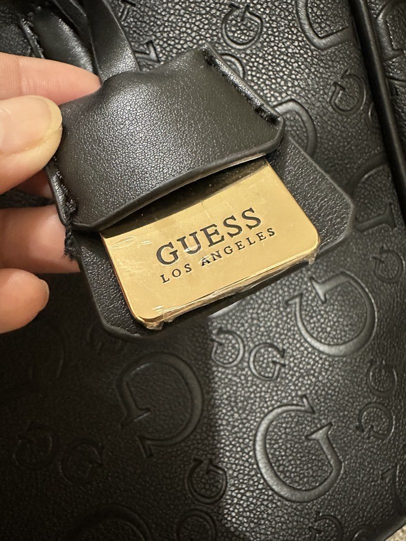 Guess black bag (Category: Purses & Pouches) located in Taguig. Submitted by honeyy19 (Listing ID 1462911392, Image 2). Description: Used once. Brand name still covered in plastic. Pristine condition! RFS - too many bags, hindi nagagamit. Sayang! .