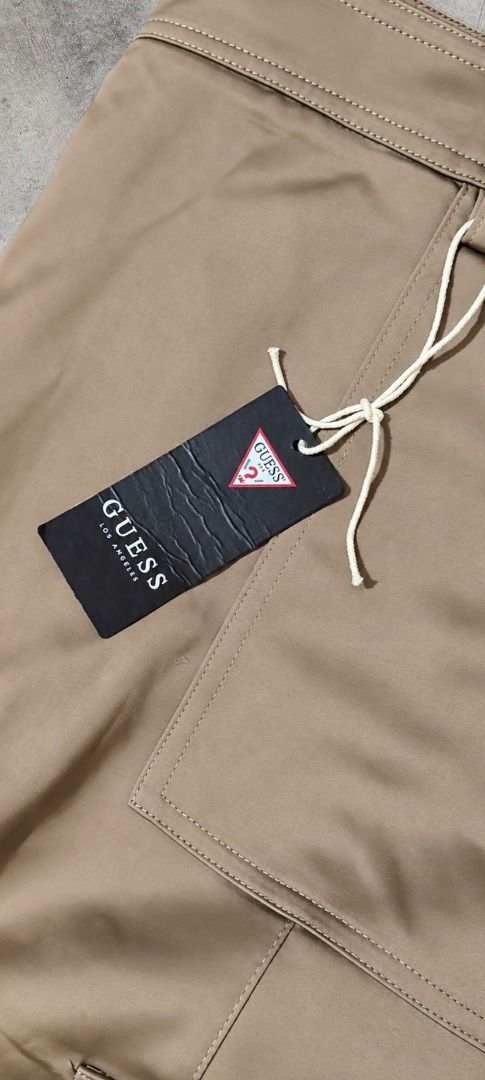 Guess Cargo Pants Khaki XL (Category: Jeans) located in Caloocan City. Submitted by zealgem.7c9bb5 (Listing ID 1463071501, Image 3). Description: GUESS Cargo Pants . Not your ordinary khaki, this pair has a coated, subtle glossy finish that gives it a clean, elevated look. Super sleek and easy to style! . Details: • Brand: Guess • Waist: 34–36 inches • Length: 39 inches • Material / Finish: Coated / subtle sheen, premium fabric finish • Features: