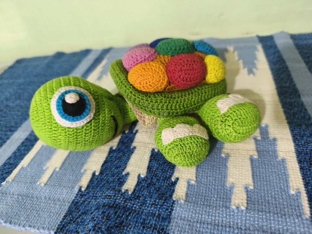 Handmade Crocheted Turtle Holder for Cups or Glasses (Category: Handmade Craft) located in Bulacan. Submitted by jvblaguard08460 (Listing ID 1463009937, Image 1). Description: - Adorable green crocheted turtle - Features a vibrant shell with colorful circle patterns - Can hold cups or glasses, making it a functional accessory - Ideal for desk decoration - Unique and handmade gift idea.