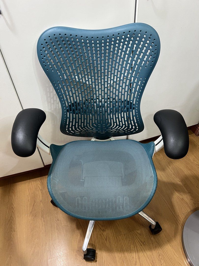 Herman Miller Mirra 2 (Category: Office Furniture & Fixtures) located in Manila. Submitted by darrensyy (Listing ID 1463092575, Image 1). Description: - Ergonomic office chair in a stylish teal color. - Breathable mesh back and seat for maximum comfort. - Adjustable armrests for personalized support. - Smooth-rolling casters for effortless mobility. - Ideal for extended work sessions. - Shows minor signs of use on the seat mesh. - Overall in good