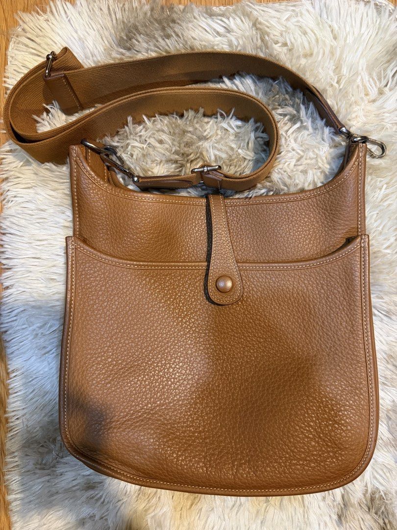 Hermes Evelyne PM Shoulder Bag Brown Leather (Category: Luxury Bags & Wallets) located in Manila. Submitted by hairaen (Listing ID 1463005153, Image 2). Description: - Authentic Hermes Evelyne bag - TPM size - Classic brown leather - Iconic perforated H logo on front - Adjustable canvas strap for crossbody/shoulder wear - Clean interior - Ideal everyday bag.