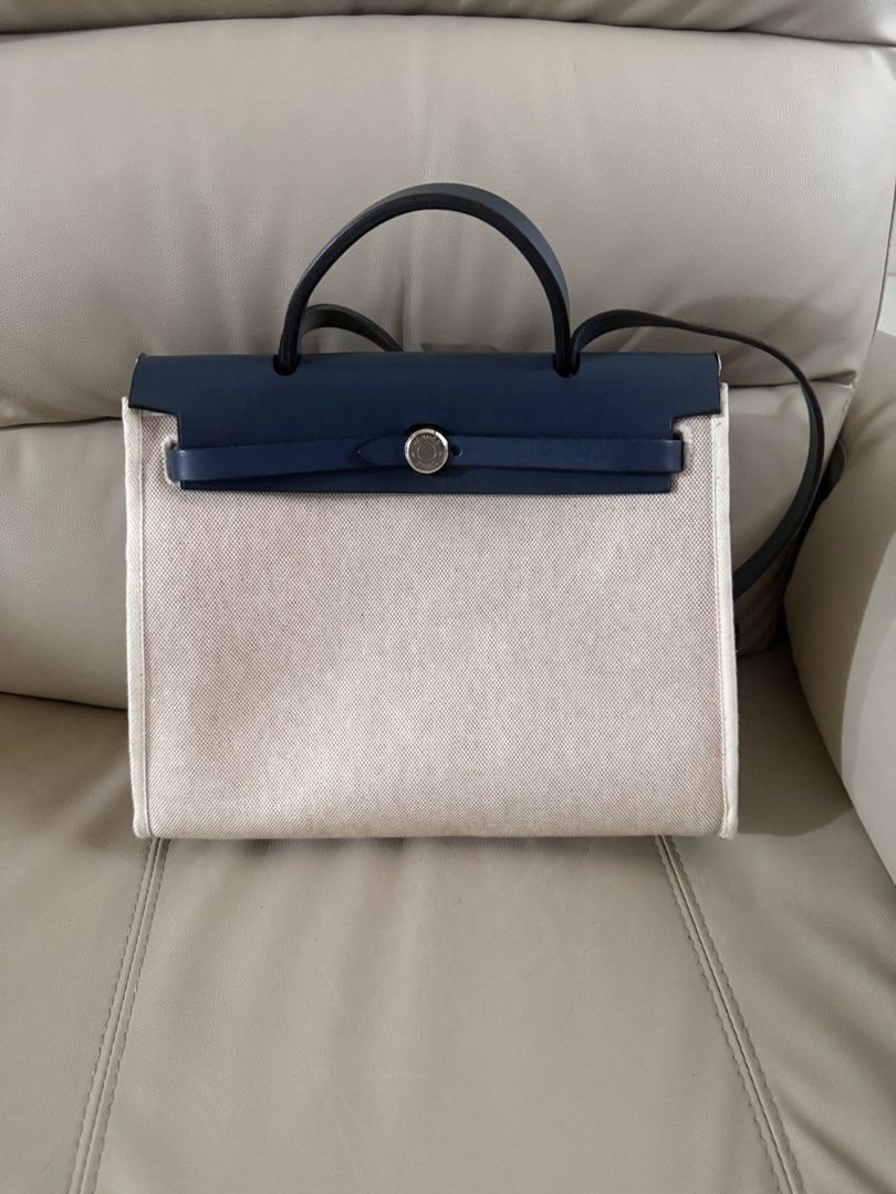 Hermes Herbag Zip Bag Navy Canvas Leather (Category: Luxury Bags & Wallets) located in Pasay City. Submitted by msthriftshopp (Listing ID 1463003401, Image 1). Description: - Authentic Hermes Herbag - Color: Navy blue leather top and handles, natural canvas body - Hardware: Silver, includes lock and keys - Features: Detachable shoulder strap, interior no zipper pocket - Condition: Great for everyday use, spacious interior No Box no dust bag ***Wi