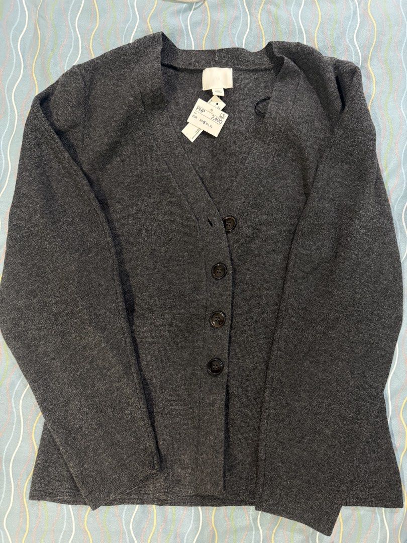H&M Dark Grey V-Neck Button-Up Cardigan (Category: Coats, Jackets and Outerwear) located in Quezon City. Submitted by francfgr (Listing ID 1463053315, Image 3). Description: - Brand: H&M - Color: Dark Grey - Style: V-neck cardigan - Features: Button-up front, long sleeves - Condition: Brand new with original tag attached - Original Price: PHP 2,490.
