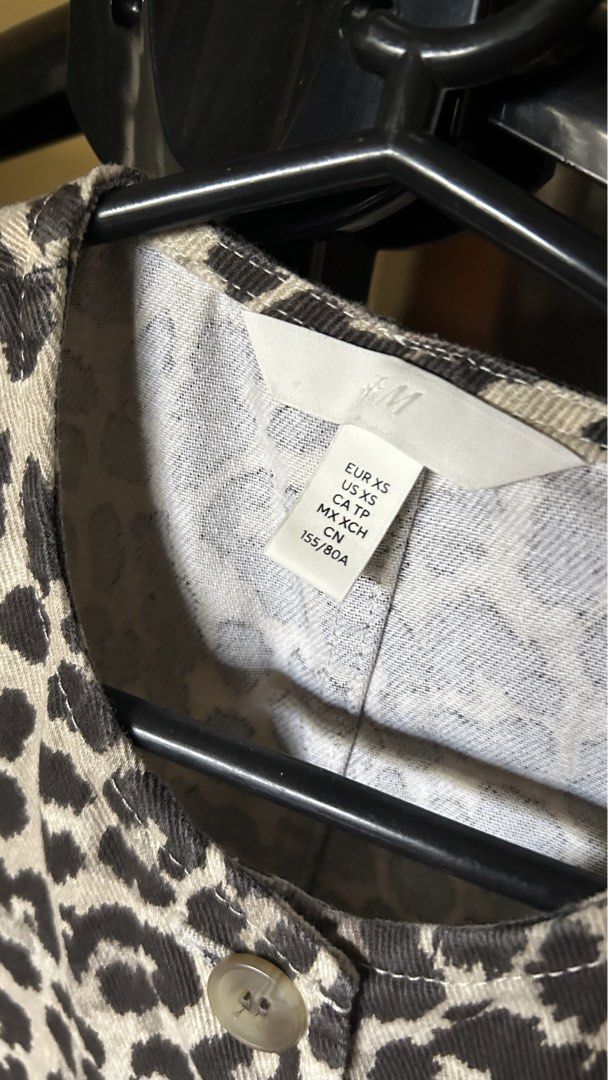 H&M Leopard Print Button-Up Denim Vest Top (Category: Others Tops) located in Angeles City. Submitted by louisee. (Listing ID 1463011091, Image 3). Description: Description: Brand: H&M Size: EUR XS / US XS Color: Beige & Dark Brown Leopard Print Condition: 9.5/10 (Excellent condition, like new) Details: * Trendy button-up front closure * Structure woven twill / denim-style material * Crew neck/round neckline design .
