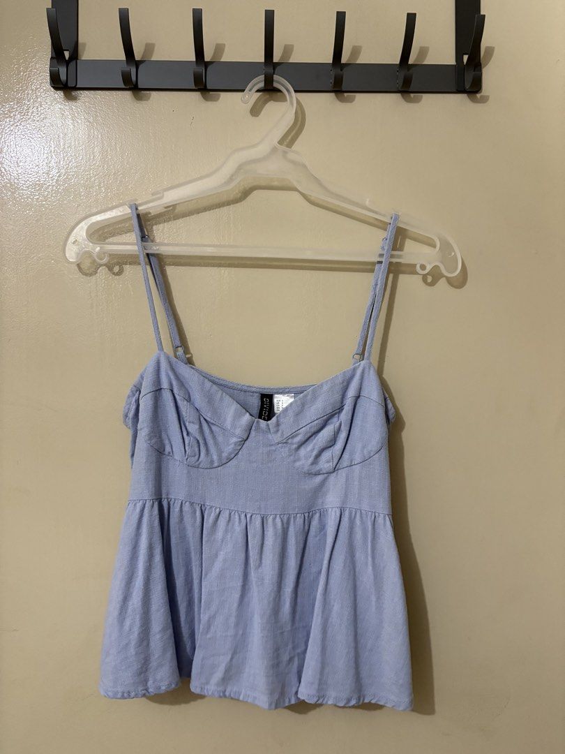 H&M Light Blue Bustier Babydoll Top (Category: Sleeveless) located in Manila. Submitted by outtacloset (Listing ID 1463010984, Image 1). Description: - Cute light blue babydoll top from H&M - Features adjustable straps - Sweetheart neckline - Subtle textured fabric - Versatile for casual wear or dressing up - Pairs well with jeans or skirts.