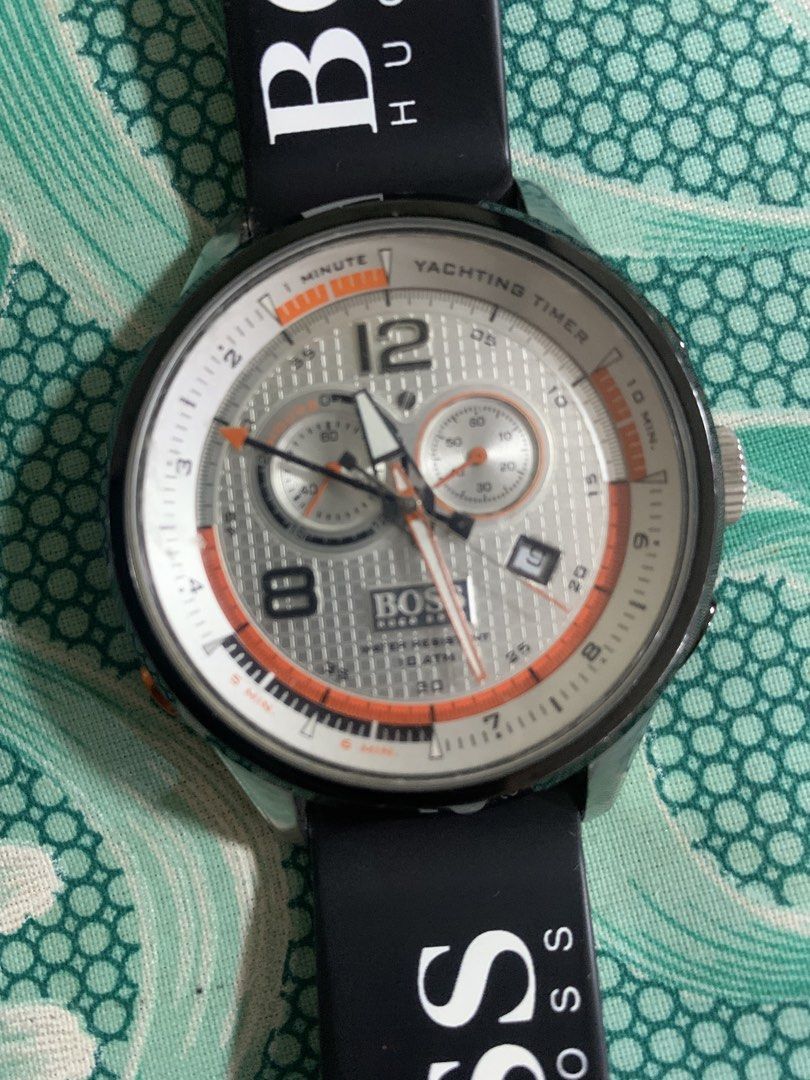 Hugo Boss Chronograph Yachting Timer Watch (Category: Men's Watches) located in Manila. Submitted by zealocean.4c3a50 (Listing ID 1463017086, Image 1). Description: - Hugo Boss watch with yachting timer function - Striking silver dial with vibrant orange accents - Comfortable black rubber strap featuring BOSS HUGO BOSS branding - Water resistant up to 10 ATM (100 meters) - Features chronograph subdials for precise timing - Convenient date window 