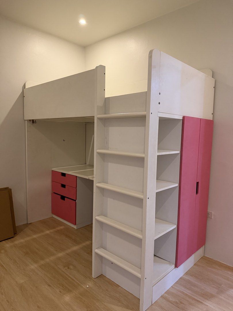 Ikea Loft Bed (Category: Bed Frames & Mattresses) located in Cainta. Submitted by itskathleen (Listing ID 1462998149, Image 2). Description: - Loft bed with integrated desk, shelves, and wardrobe - White frame with pink drawer fronts and wardrobe doors - Ideal space-saving solution for a child's room - Ladder included for easy access to the top bunk - Ample storage for clothes and books.