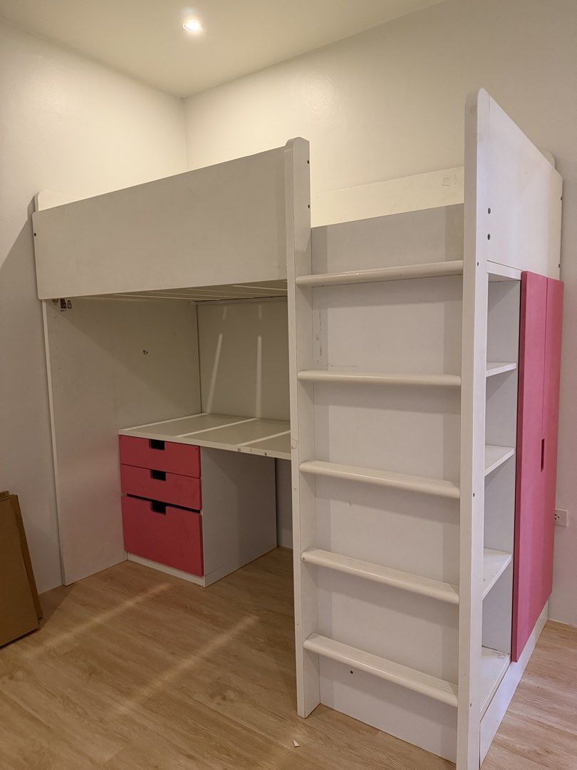 Ikea Loft Bed (Category: Bed Frames & Mattresses) located in Cainta. Submitted by itskathleen (Listing ID 1462998149, Image 3). Description: - Loft bed with integrated desk, shelves, and wardrobe - White frame with pink drawer fronts and wardrobe doors - Ideal space-saving solution for a child's room - Ladder included for easy access to the top bunk - Ample storage for clothes and books.