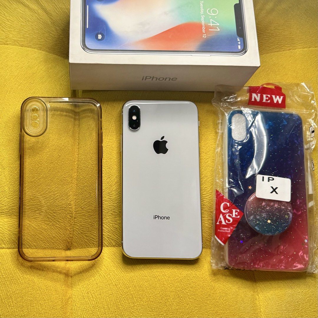 Iphone X 256gb (Category: iPhone X Series) located in Manila. Submitted by rnc.shop (Listing ID 1462952206, Image 2). Description: FOR SALE: iPhone X Silver 256GB Transaction: Meetup Manila location Specs: Silver color, 256GB storage, BH: 100% (battery replaced) Condition: Lady owned, smooth performance, no functional issues, Face ID & TrueTone working, minimal scratches on sides as seen in photos, the cracks are just the screen protector Inclusi