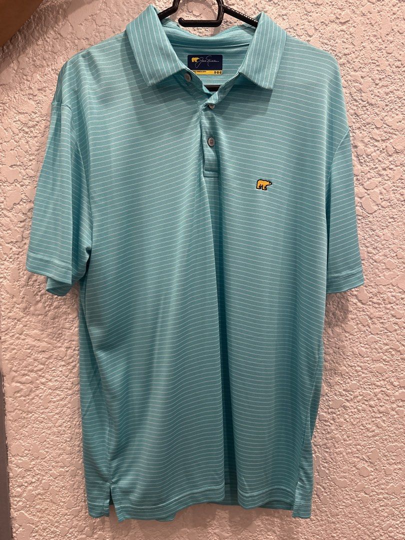 Jack Nicklaus Golf Polo Shirt (Category: Tshirts & Polo Shirts ) located in Paranaque City. Submitted by v_ray (Listing ID 1462977589, Image 1). Description: - Aqua blue polo shirt - Thin white stripes - Iconic Gold Bear logo on chest - Classic collar and button placket - Ideal for golf or casual wear - Comfortable and breathable fabric.
