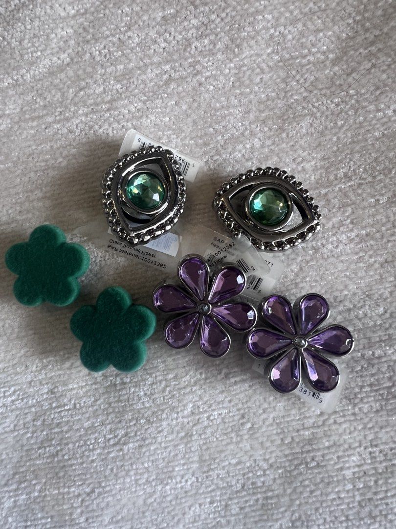 Jibbitz| Crocs | Original Evil Eye and Flower (Category: Charms) located in Pasig City. Submitted by declutter-tinted (Listing ID 1462966378, Image 1). Description: All items are original and never been used. • Set of 3 — ₱1,000 • 2 Evil Eye Charms with Green Gems — ₱475 • 2 Purple Flower Charms — ₱475 • 2 Green Flower Charms — ₱250 📦 Shipping: SF shouldered by buyer via LBC, Lalamove, or Grab 💰 Payment: GCash / GoTyme.