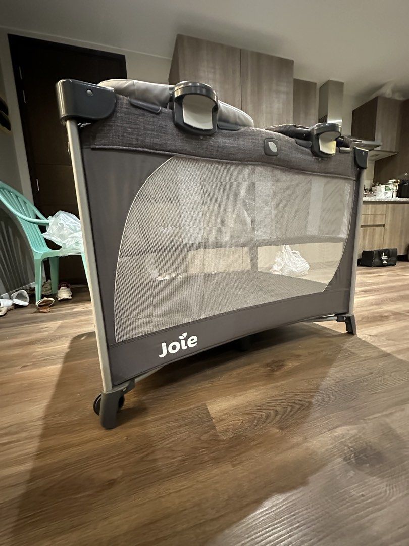 Joie Playpen Travel Cot Crib (Category: Cots & Cribs) located in Manila. Submitted by fabfinds1111 (Listing ID 1463080662, Image 2). Description: - Joie brand playpen - Includes bassinet attachment - Mesh sides for excellent ventilation - Simple to assemble and fold - Ideal for both home and travel - Comes with a mattress base - Stylish dark grey fabric.