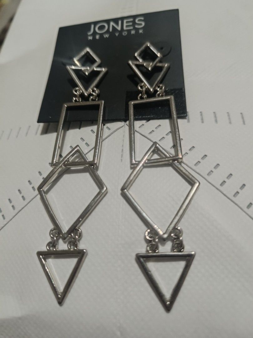 Jones New York Silver Geometric Dangle Earrings (Category: Earrings) located in Bacolod City. Submitted by jewels.of.joy (Listing ID 1463004724, Image 1). Description: - Brand: Jones New York - Style: Silver Dangle Earrings - Design: Modern geometric shapes (squares, diamonds, triangles) - Length: Long drop style - Perfect for: Adding a modern touch to any outfit - Condition: Comes on original backing card.