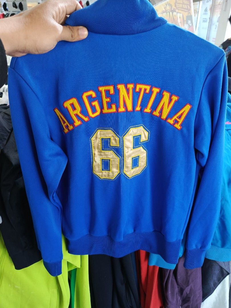 Kappa Argentina '66 Track Jacket Blue Medium (Category: Coats, Jackets and Outerwear) located in Cabatuan. Submitted by penthegreat (Listing ID 1463112358, Image 2). Description: - Blue Kappa track jacket - Features Argentina '66 graphic - Full zip front with pockets - Ribbed collar, cuffs, and hem - Made of 100% cotton - Tagged as Medium - Ideal for casual wear or sports.
