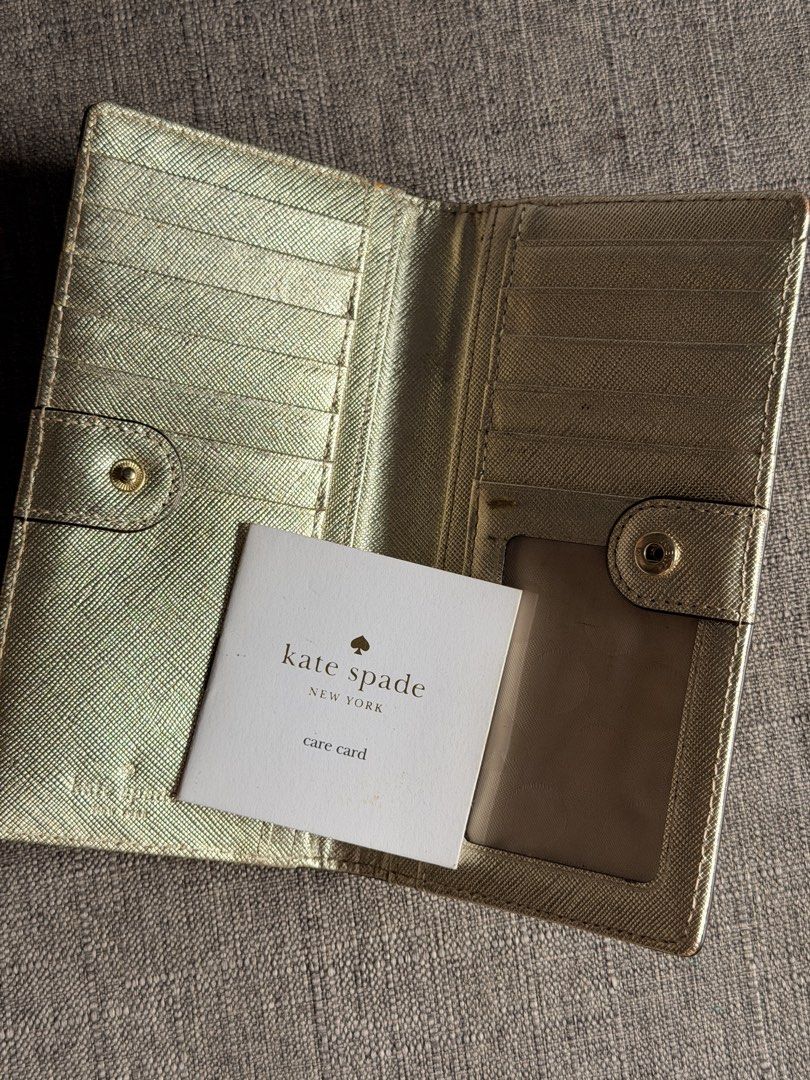 Kate Spade Gold Textured Long Wallet (Category: Wallets & Card holders) located in Marikina City. Submitted by mddc0808 (Listing ID 1463002170, Image 3). Description: - Genuine Gold Kate Spade Wallet -Pre-owned -Gold Mettalic -Bifold -Multiple card slots -6.5” x 3.5” -With minor flaws but GOOD CONDITION overall -9.8/10 ⭐️ -₱2,500 nego 📍 Marikina City.