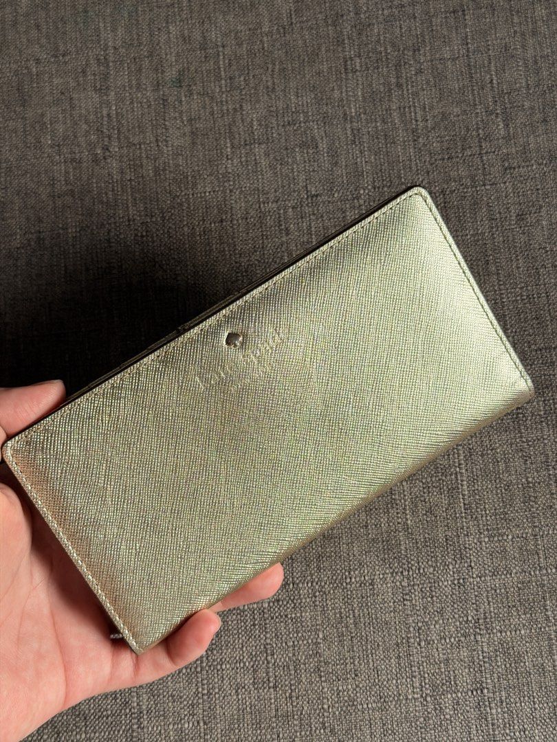 Kate Spade Gold Textured Long Wallet (Category: Wallets & Card holders) located in Marikina City. Submitted by mddc0808 (Listing ID 1463002170, Image 1). Description: - Genuine Gold Kate Spade Wallet -Pre-owned -Gold Mettalic -Bifold -Multiple card slots -6.5” x 3.5” -With minor flaws but GOOD CONDITION overall -9.8/10 ⭐️ -₱2,500 nego 📍 Marikina City.