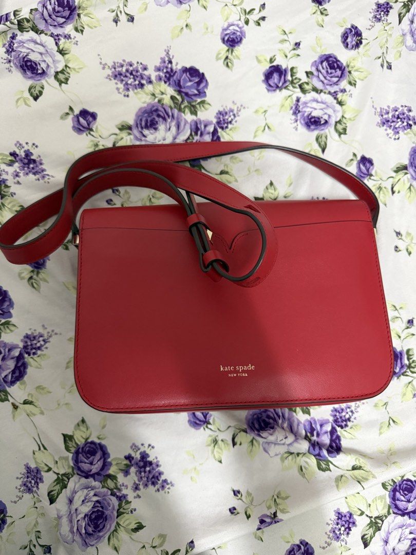 Kate Spade Red Spade Heart Shoulder Bag (Category: Luxury Bags & Wallets) located in Navotas City. Submitted by lourvecamille (Listing ID 1462953628, Image 2). Description: - Authentic red nicola Kate Spade shoulder bag - Signature spade logo with a charming pink heart detail (Twistlock) - Elegant gold hardware - Convenient interior zip pocket - Adjustable strap for customized fit - Ideal for everyday errands or a stylish night out.