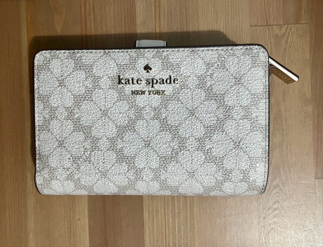 Kate Spade "Spade Flower Jacquard" Wallet (Category: Wallets & Card holders) located in Paranaque City. Submitted by simonthecutecatboy (Listing ID 1463003063, Image 1). Description: - Authentic Kate Spade wallet in Spade Flower Jacquard pattern. - Chic dark beige and cream colorway. - Classic bi-fold style with secure snap closure. - Features ample card slots for organization. - Includes a convenient zip pocket for coins. - Original retail price
