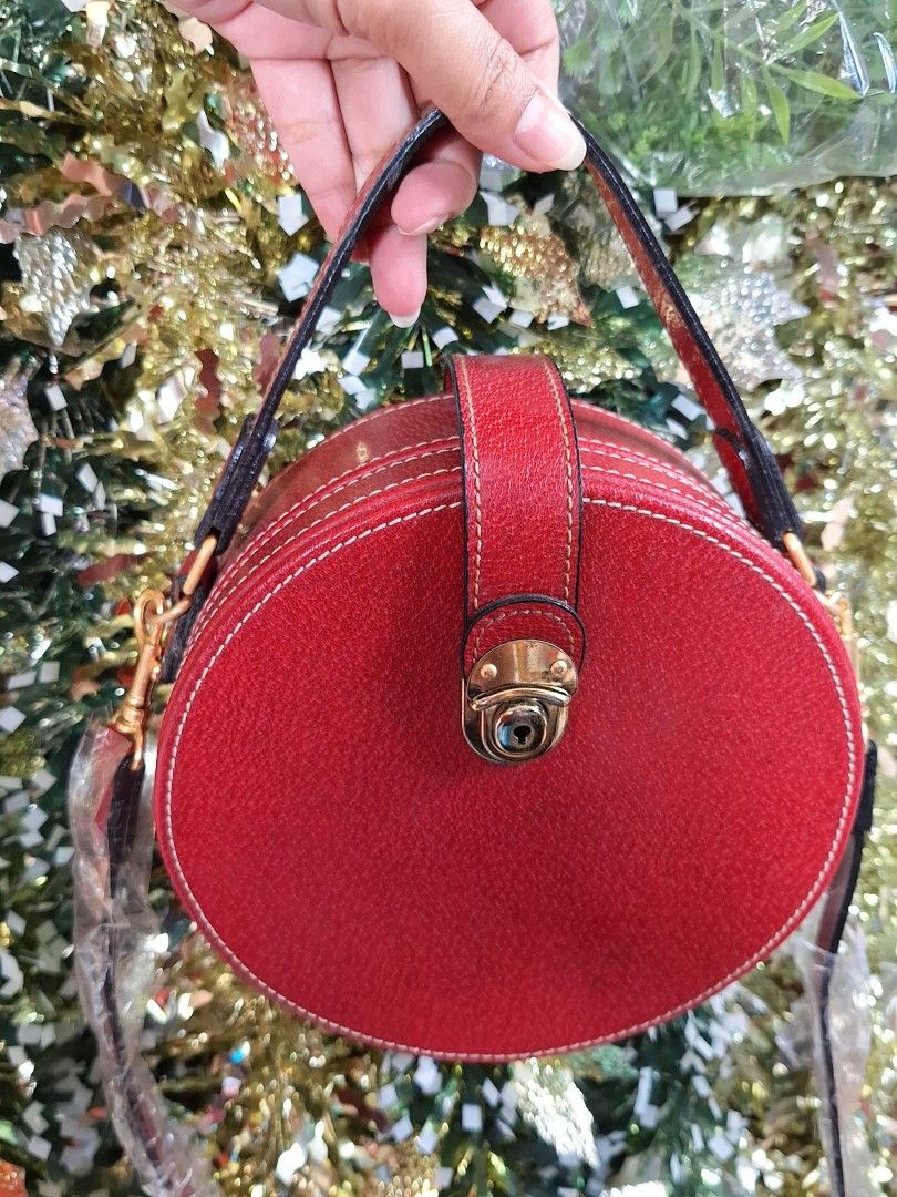 KENZO Red Round Handbag/Sling bag (Category: Luxury Bags & Wallets) located in Pasig City. Submitted by shopwithxandra (Listing ID 1462892455, Image 2). Description: - Adorable round handbag in a vibrant red color. - Features a convenient top handle. - Includes a detachable shoulder strap for versatile carrying options. - Secure gold turn-lock closure. - An excellent accessory to add a pop of color to any outfit..