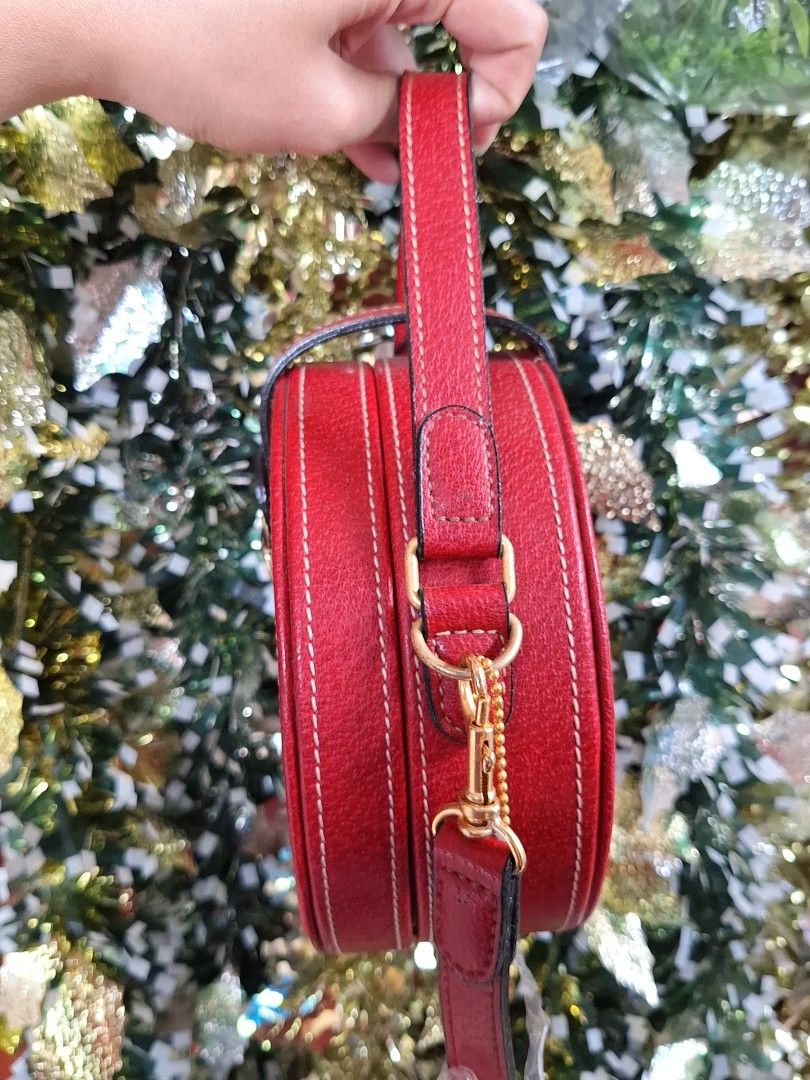 KENZO Red Round Handbag/Sling bag (Category: Luxury Bags & Wallets) located in Pasig City. Submitted by shopwithxandra (Listing ID 1462892455, Image 3). Description: - Adorable round handbag in a vibrant red color. - Features a convenient top handle. - Includes a detachable shoulder strap for versatile carrying options. - Secure gold turn-lock closure. - An excellent accessory to add a pop of color to any outfit..