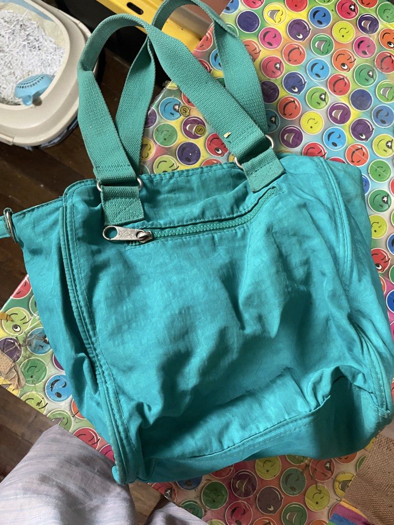 Kipling Teal Nylon Tote Bag (Category: Tote Bags) located in Quezon City. Submitted by garagesaleonline (Listing ID 1462891523, Image 2). Description: - Teal Kipling tote bag - Durable nylon material - Two comfortable shoulder straps - Convenient zippered front pocket - Secure zippered back pocket - Includes signature Kipling monkey keychain - Ample space for all your essentials.