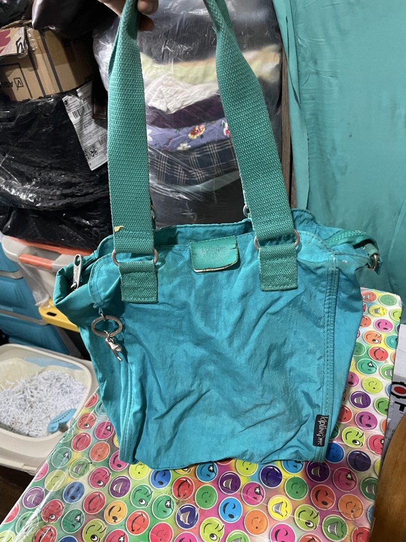 Kipling Teal Nylon Tote Bag (Category: Tote Bags) located in Quezon City. Submitted by garagesaleonline (Listing ID 1462891523, Image 1). Description: - Teal Kipling tote bag - Durable nylon material - Two comfortable shoulder straps - Convenient zippered front pocket - Secure zippered back pocket - Includes signature Kipling monkey keychain - Ample space for all your essentials.
