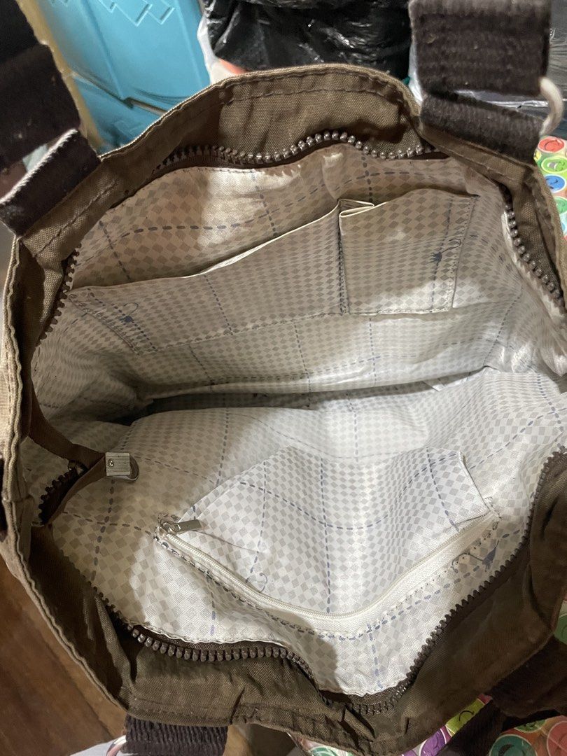 Kipling Tote Bag (Category: Tote Bags) located in Quezon City. Submitted by garagesaleonline (Listing ID 1462892056, Image 3). Description: - Brown Kipling tote bag - Front zipper pocket - Two top handles - Multiple interior pockets, including a zippered one - Ideal for everyday use - Spacious enough for essentials.