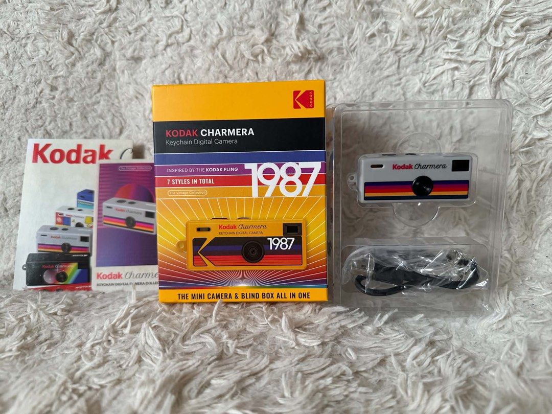 Kodak Charmera Keychain Digital Camera - 1987 Style (Category: Cameras) located in Pasig City. Submitted by nakamuraka (Listing ID 1462952412, Image 3). Description: - Kodak Charmera keychain digital camera - Inspired by the Kodak Fling - Comes in a blind box (7 styles total) - This is the 1987 style - Mini camera and blind box combined - Includes charging cable.