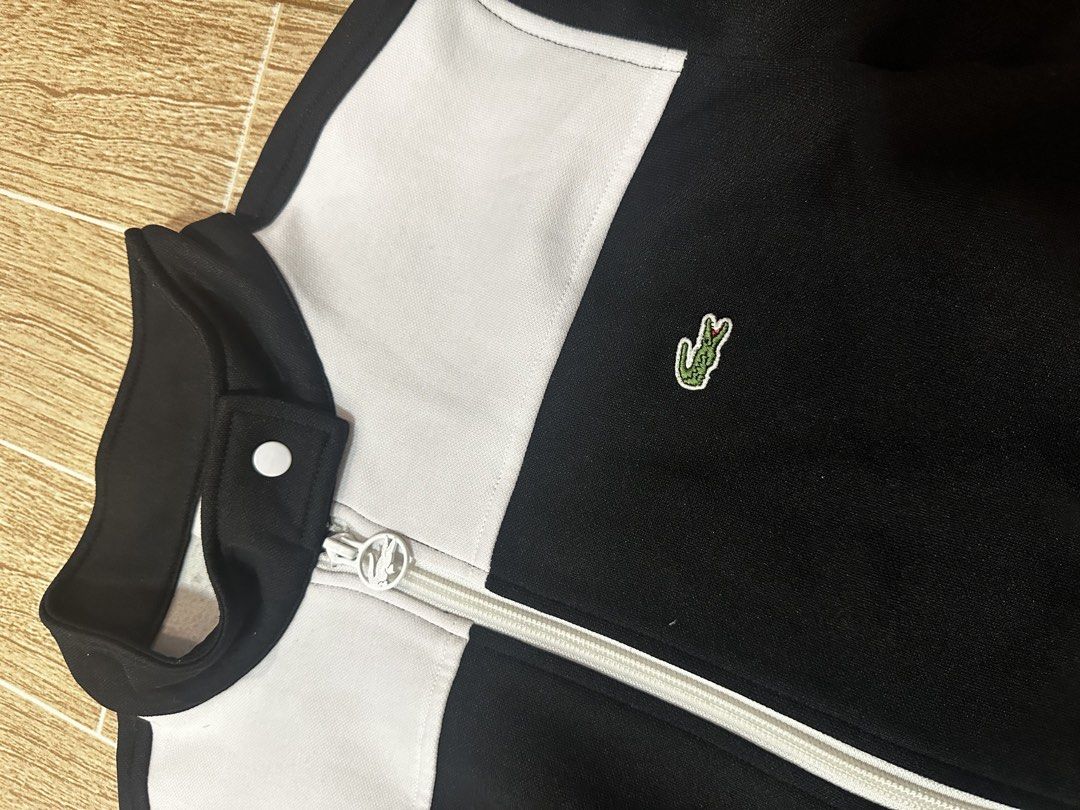Lacost zip up track jacket (Category: Coats, Jackets and Outerwear) located in Taytay. Submitted by rthriftshoppp (Listing ID 1463030268, Image 2). Description: - Brand: Lacoste - Type: Zip-up track jacket - Color: Black and white - Features: Iconic crocodile logo, full zip closure - Condition: Great, pre-loved - Style: Sporty, casual Lacoste zip up track jacket Womens Size 40 Or S to M 19.5 W 21 L No issue Complete tags See pics for reference .