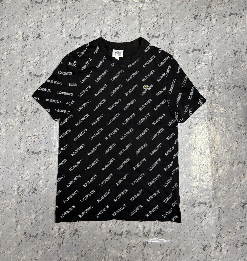 Lacoste All Over Logo T-Shirt (Category: Tshirts & Polo Shirts ) located in Manila. Submitted by raven236 (Listing ID 1462899177, Image 1). Description: - Brand: Lacoste - Color: Black - Pattern: Repeating white logo - Neckline: Classic crew neck - Sleeves: Short sleeves - Estimated Size: Medium (based on tag) - Style: Casual, simple, stylish.