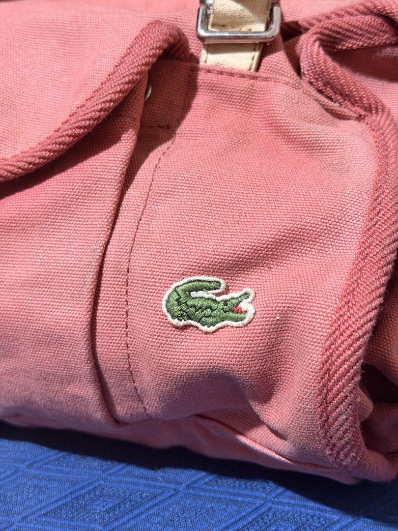 Lacoste Canvas Shoulder Bag Coral Pink (Category: Shoulder Bags) located in Quezon City. Submitted by mel.highmoons (Listing ID 1463015643, Image 2). Description: Ganda ng color and very spacious inside! May mga flaws lang sya kaya selling for cheap na lang. But other than that Super okay pa and kapal ng tela!!! MOP: Gcash/BPI/Bank Transfer MOD: Lalamove, Flash Express Shipping fee to be shouldered by buyer. .