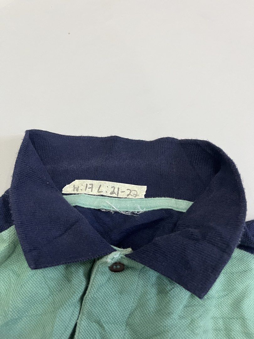Lacoste Colorblock Polo Shirt (Category: Tshirts & Polo Shirts ) located in Mabalacat. Submitted by aas_thriftfings (Listing ID 1462926196, Image 3). Description: - Classic Lacoste Polo Shirt - Color: Light Green body with Navy Blue sleeves and collar - Features a small embroidered crocodile logo on the chest - Material: 100% Cotton - Ideal for casual wear.