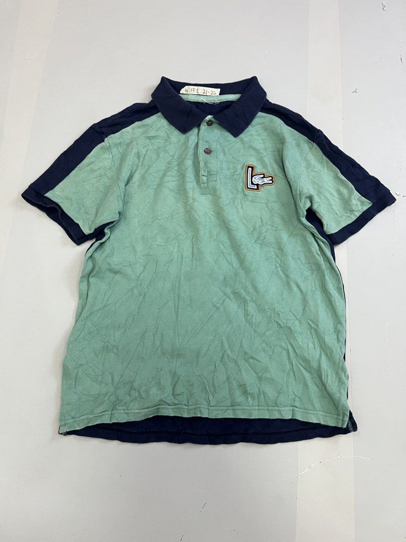 Lacoste Colorblock Polo Shirt (Category: Tshirts & Polo Shirts ) located in Mabalacat. Submitted by aas_thriftfings (Listing ID 1462926196, Image 1). Description: - Classic Lacoste Polo Shirt - Color: Light Green body with Navy Blue sleeves and collar - Features a small embroidered crocodile logo on the chest - Material: 100% Cotton - Ideal for casual wear.