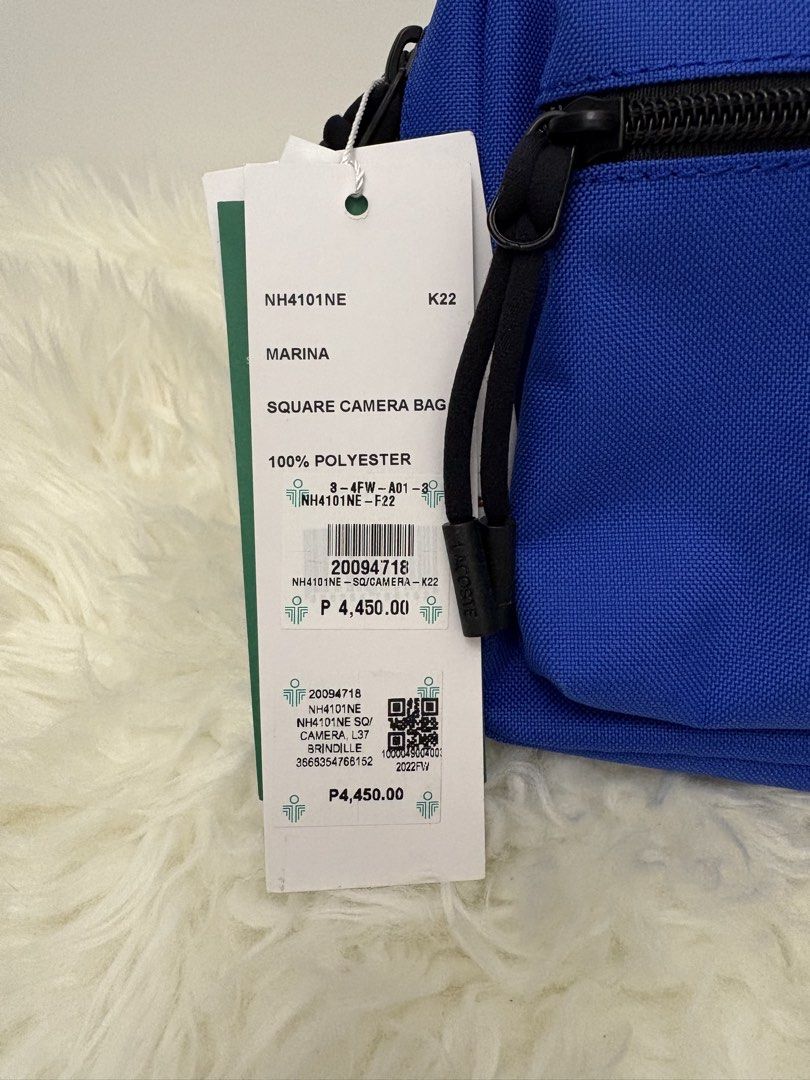 Lacoste Marina Square Camera Bag Blue 100% Polyester (Category: Cross-body Bags) located in Quezon City. Submitted by AAAAAF14 (Listing ID 1463085170, Image 2). Description: - Authentic Blue Lacoste Marina Square Camera Bag - Made of 100% Polyester - Features a front zip pocket and a main zip compartment - Adjustable strap for comfortable wear - Original tag still attached - Original Price: P4,450.00.