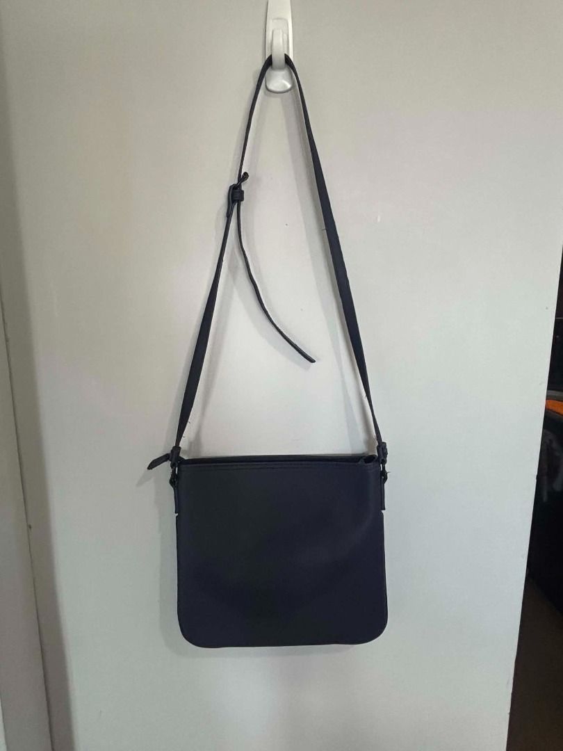 Lacoste Navy Blue Canvas Crossbody Bag (Category: Cross-body Bags) located in Mandaluyong City. Submitted by capurcosjo05601 (Listing ID 1463043716, Image 1). Description: - Navy blue Lacoste crossbody bag - Made of durable canvas - Adjustable strap for comfort - Secure zipper closure - Ideal for everyday use - Spacious interior for essentials - Classic and simple design.